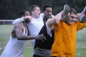 Friends Helping a Friend Cross the Line in a Race